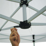 Close-up of a hand turning the crank mechanism on the frame of a pop-up canopy tent.