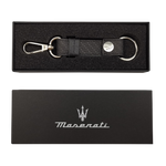 A black leather keychain with a metal carabiner and a snap button, featuring a debossed Trident and Maserati logo.