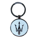 A chrome metal keyring with a polished white resin coating, featuring the Maserati logo lasered on it. The keychain is circular with a visible branding on both sides.